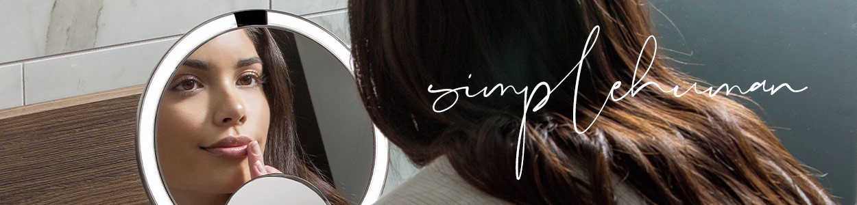 Moodbild im Bannerformat mit dem Schriftzug "Simplehuman", das eine Frau zeigt, die sich im Badspiegel Sensor betrachtet