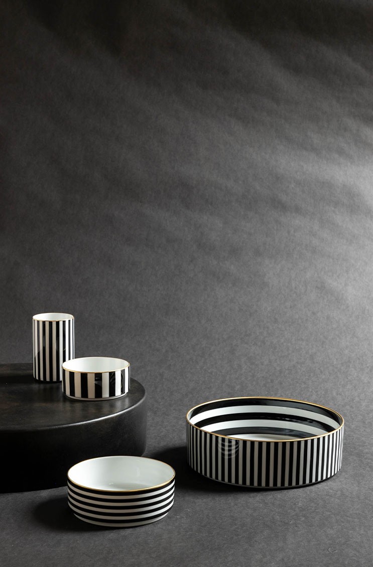 Geschirr mit schwarz-weißen geometrischen Mustern von Sieger by Fürstenberg auf einem schwarzen Untergrund