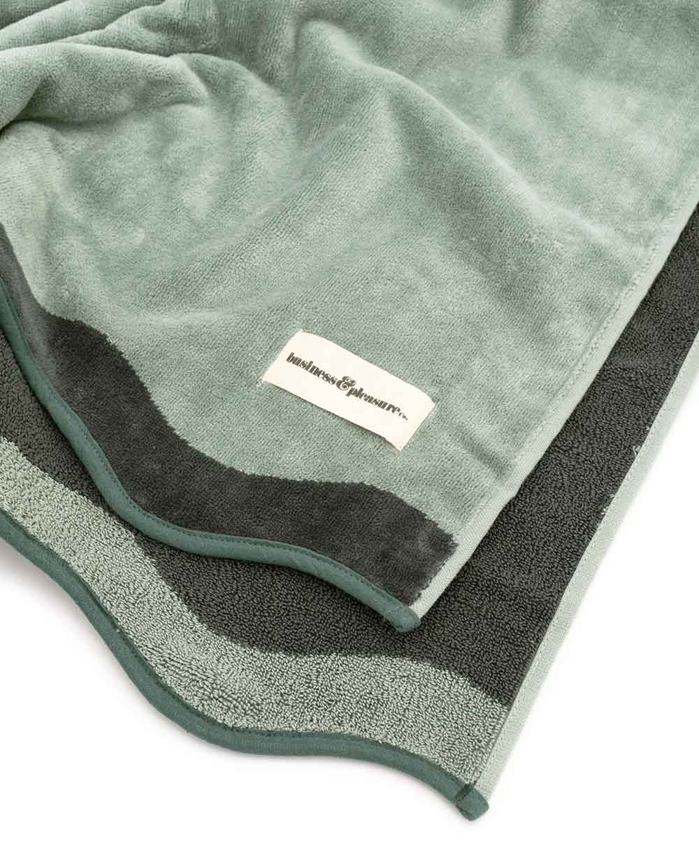 Das Strandtuch „Beach Towel“ in der Farbe Rivie Green aus der 2024 Sommer Kollektion von Business & Pleasure im RAUM concept store.